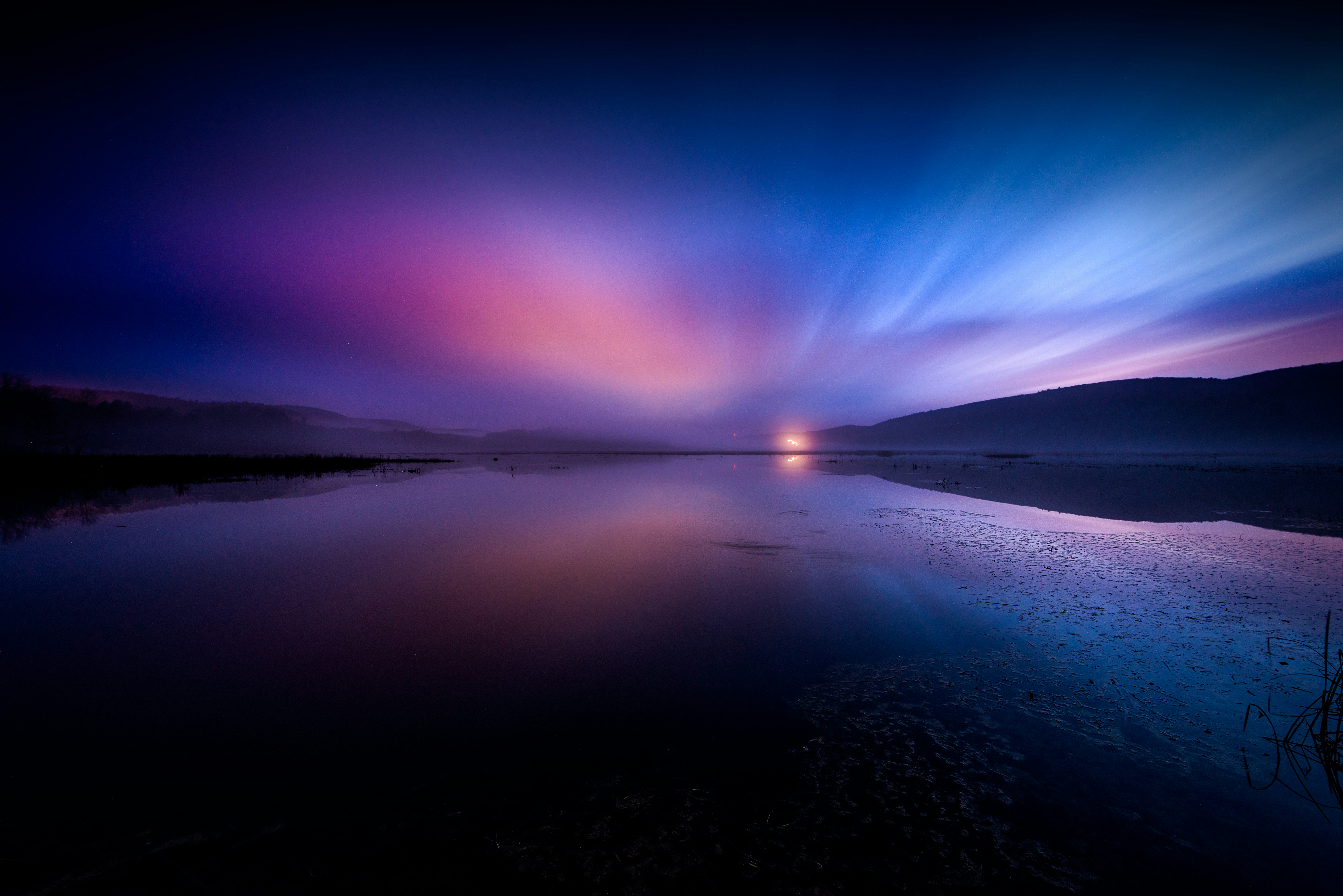 landscape photography of body of water under dramatic sky